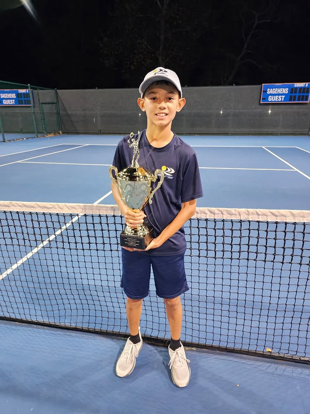 Junior with trophy at night